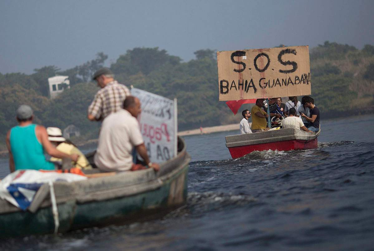 In this Sunday, July 3, 2016 photo, fishermen protest the pollution in the Guanabara bay, in Rio de Janeiro, Brazil. Rio state officials have acknowledged a real cleanup of Guanabara will take 20 years after organizers promised to do it for the Olympics, with the city still pouring at least half of its untreated sewage into its surrounding waters, including Guanabara.