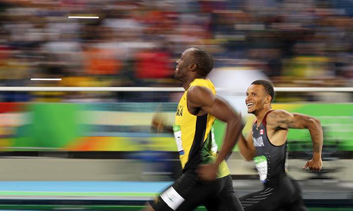 Jamaica’s Usain Bolt and Canada’s Andre De Grasse smile as they compete in the 200m semi-finals.