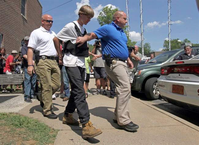 In this Thursday, June 18, 2015 file photo, Charleston, S.C., shooting suspect Dylann Storm Roof is escorted from the Shelby Police Department in Shelby, N.C. 