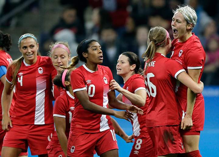 Canada's Sophie Schmidt, right, celebrates after scoring her team's first goal during a quarter-final match of the women's Olympic soccer tournament against France in Sao Paulo, Brazil, Friday Aug. 12, 2016. 