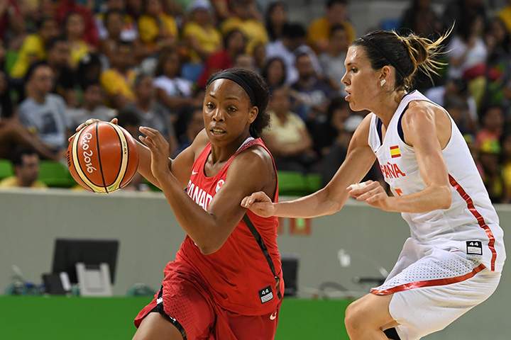 Canada’s shooting guard Nirra Fields works around Spain’s guard Anna Cruz during a women’s round Group B basketball at the Youth Arena in Rio de Janeiro on August 14, 2016 during the Rio 2016 Olympic Games.