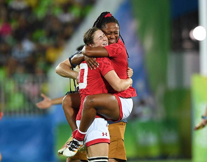 Canada’s Charity Williams, right, jumps into the arms of Hannah Darling as they win bronze defeating Great Britain’s in women’s rugby sevens at the 2016 Olympic Summer Games in Rio de Janeiro, Brazil on Monday, Aug. 8, 2016.