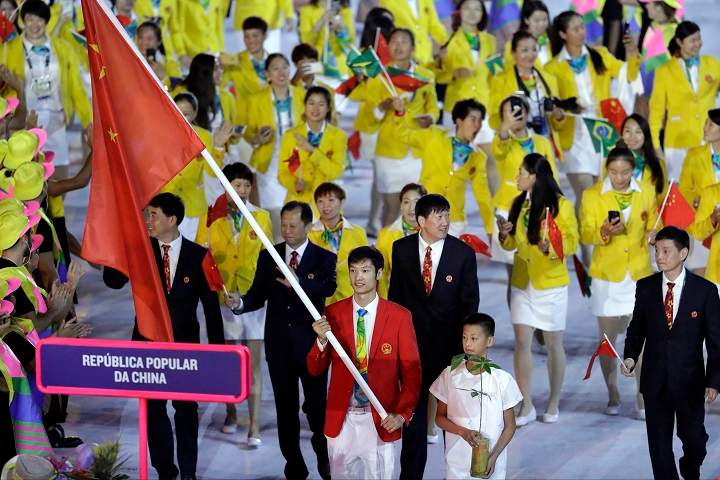 Lei Sheng carries the flag of China during the opening ceremony for the 2016 Summer Olympics in Rio de Janeiro, Brazil, Friday, Aug. 5, 2016.