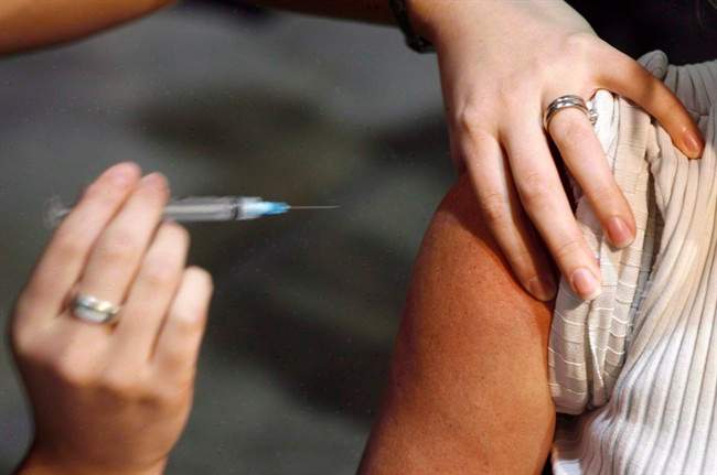 A person gets a shot during a flu vaccine program in Calgary on Oct. 26, 2009. A study has found that people who live in provinces that allow pharmacists to give flu shots are more likely to get vaccinated against the seasonal bug than those living in jurisdictions without such a policy.