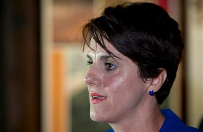 Local PQ candidate, Algerian-born Djemila Benhabib responds to questions during a news conference with PQ leader Pauline Marois on Tuesday, August 14, 2012 in Trois-Rivieres, Que. A slander trial is set to begin next month pitting Benhabib, a fiercely secular, feminist author against a private, Muslim school in Montreal she likened to militant Islamic training camps in Afghanistan and Pakistan.