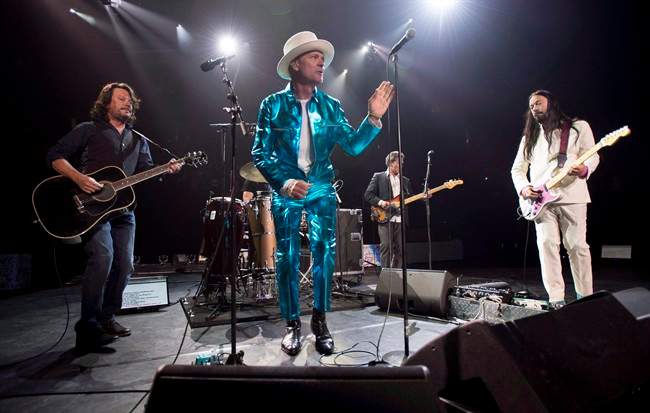 Frontman of the Tragically Hip, Gord Downie, centre, leads the band through a concert in Vancouver on July 24, 2016.