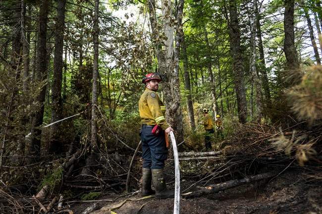 Firefighters with the Department of Natural Resources fight the Seven Mile Lake forest fire in Maitland Bridge, N.S. near Kejimkujik National Park on Thursday, August 11, 2016.