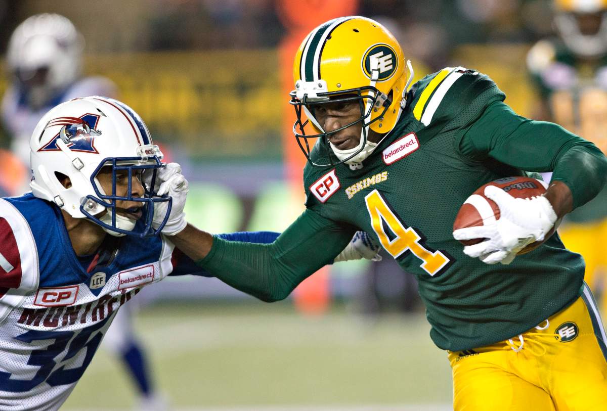 Montreal Alouettes' Greg Henderson (35) tries to tackle Edmonton Eskimos' Adarius Bowman (4) during second half CFL action in Edmonton on Thursday, August 11, 2016. THE CANADIAN PRESS/Jason Franson.
