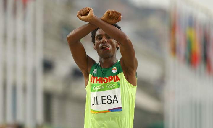 As Feyisa Lilesa crossed the finish line Sunday, he threw his arms over his head making an “X” in a show of support for members of his Oromo tribe. (REUTERS/Athit)