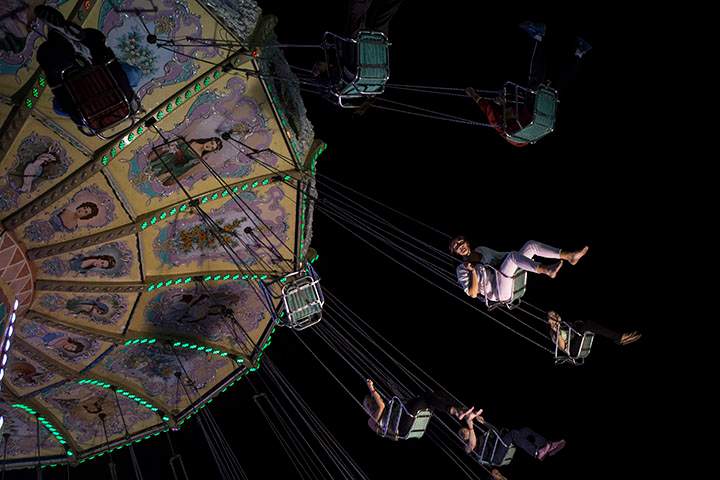 Visitors take the swing ride at the Canadian National Exhibition in Toronto on Saturday, August 23, 2014. 