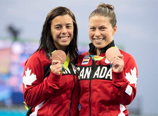 Canada’s Meaghan Benfeito (left) and Roseline Filion celebrate on the podium after their bronze medal win in women’s synchronized 10m platform diving at the 2016 Summer Olympics in Rio de Janeiro, Brazil, Tuesday, Aug. 9, 2016.