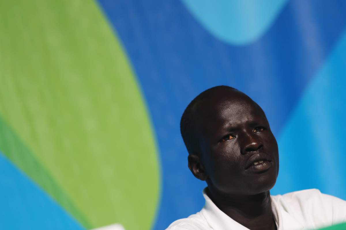 James Chiengjiek of the Olympic Refugee Team talks while attending a press conference given by the Olympic Refugee Team on July 31, 2016 in Rio de Janeiro, Brazil.