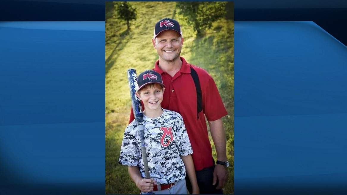 This June 2016 photo provided by David Strickland shows Caleb Thomas Schwab posing with his father Scott Schwab, a Kansas state lawmaker from Olathe. Caleb died Sunday, Aug. 7, 2016, while riding the Verruckt, a water slide that's billed as the world's largest, at the Schlitterbahn Waterpark in Kansas City, Kan.