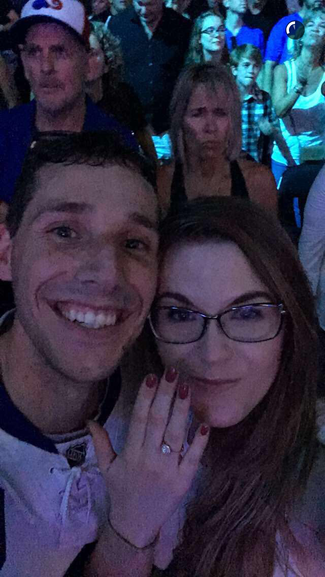 The newly-engaged couple celebrate during the Tragically Hip live performance in Kingston, Ontario Saturday night.