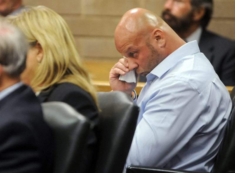 Johnny Small wipes his eyes during a hearing before Judge W. Douglas Parsons at the New Hanover County Courthouse in Wilmington, N.C., Monday, Aug. 8, 2016. 
