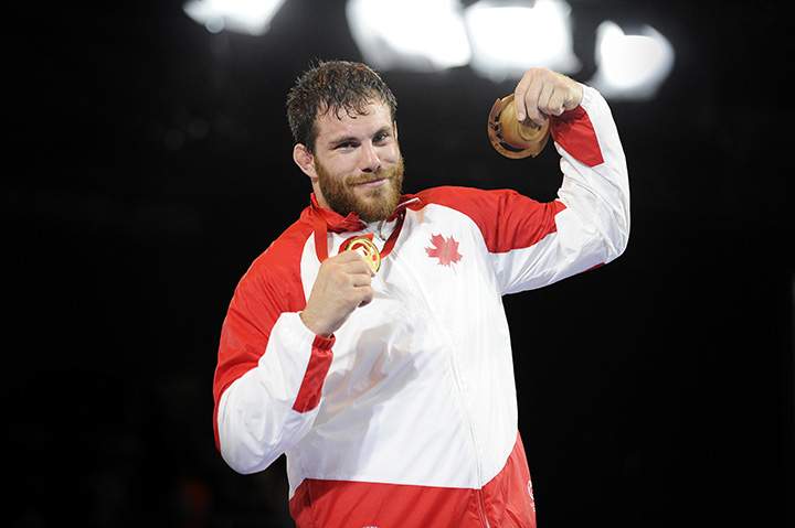 Canada’s Korey Jarvis poses with his gold medal after winning the freestyle 125kg wrestling competition at the 2014 Commonwealth Games in Glasgow, Scotland on July 29, 2014.