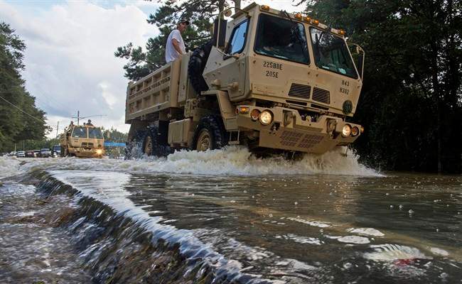 The Louisiana National Guard transports people out of flood hit areas around Walker , La., Monday, Aug. 15, 2016.