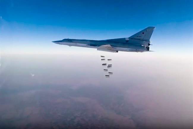 In this frame grab from video provided by the Russian Defence Ministry Press Service, Russian long range bomber Tu-22M3 flies during a strike above an undisclosed location in Syria on Sunday, Aug. 14, 2015.