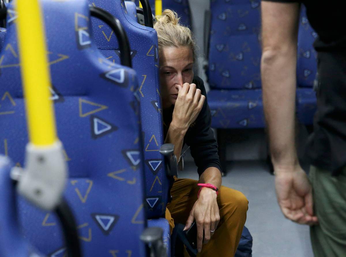 Journalist Joanna Moyse cries on an official media bus after a window shattered when driving accredited journalists to the Main Transport Mall from the Deodoro venue of the Rio 2016 Olympic Games in Rio de Janeiro, August 9, 2016. 