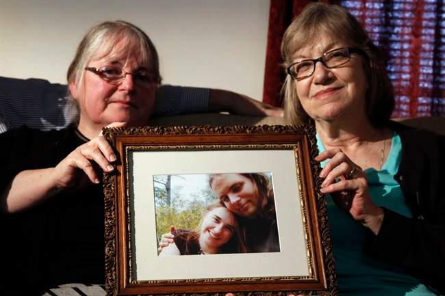 In this June 4, 2014, file photo, mother’s Linda Boyle, left and Lyn Coleman hold photo of their married children, Joshua Boyle and Caitlan Coleman, who were kidnapped by the Taliban in late 2012 in Stewartstown, Pa.