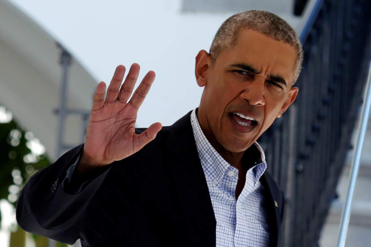 U.S. President Barack Obama waves as he walks out from the White House before his departure to view flood damaged area in Baton Rouge, in Washington, U.S., August 23, 2016.