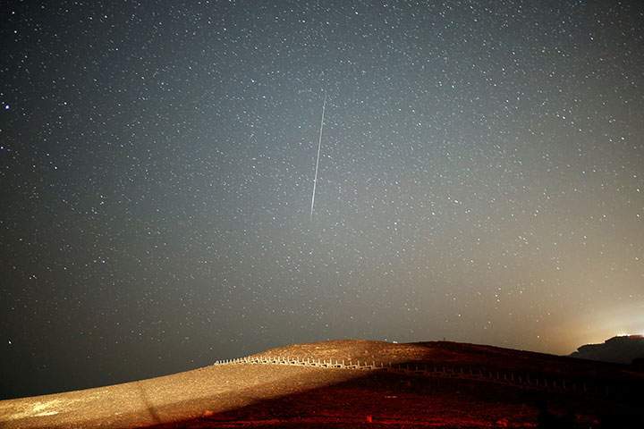 A meteor streaks across the sky in the early morning during the Perseid meteor shower in Ramon Crater near the town of Mitzpe Ramon, southern Israel, August 12, 2016.
