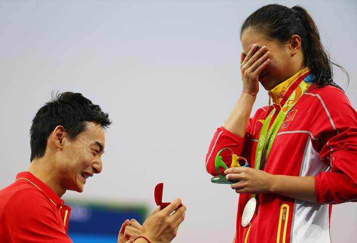 He Zi (CHN) of China recieves a marriage proposal from Olympic diver Qin Kai (CHN) of China after the medal ceremony.