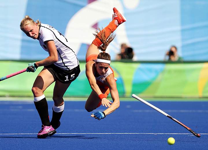 Eva de Goede of Netherlands falls while competing against Hannah Kruger of Germany during the semi-final match on August 17, 2016.