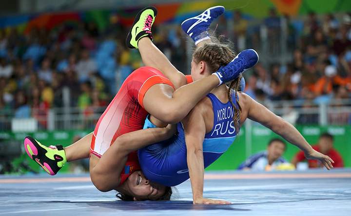 Orkhon Purevdorj of Mongolia and Valeriia Koblova of Russia compete during the women’s freestyle preliminary 58kg match.