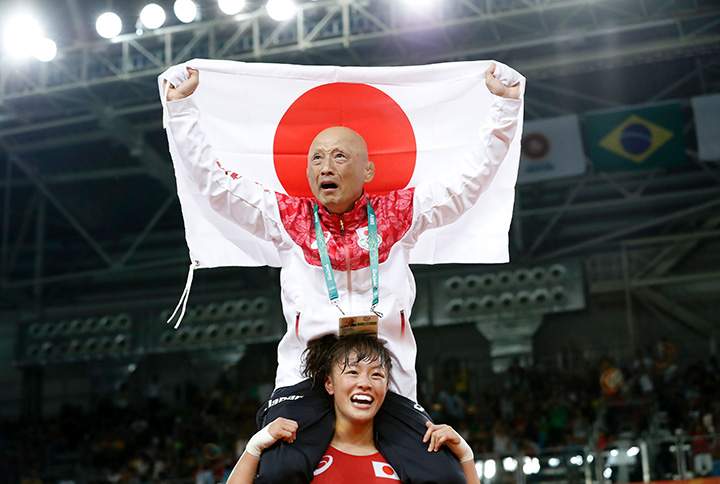 Japan’s Eri Tosaka celebrates with her coach winning against Azerbaijan’s Mariya Stadnyk in their women’s 48kg freestyle final match on August 17, 2016 in Rio de Janeiro.