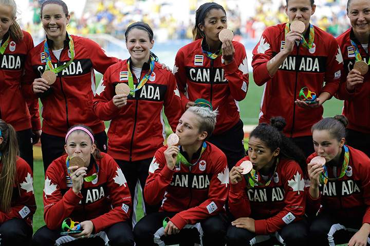 Team Canada poses for photos after winning the bronze medal in the women’s Olympic soccer tournament between Brazil and Canada at the Arena Corinthians stadium in Sao Paulo, Friday Aug. 19, 2016.