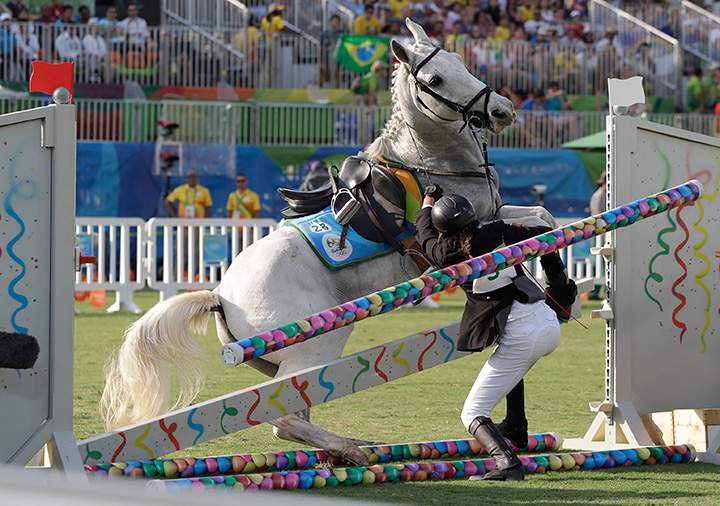 Ilke Ozyusel of Turkey falls during equestrian portion of the women’s modern pentathlon at the Summer Olympics in Rio de Janeiro, Brazil, Friday, Aug. 19, 2016.