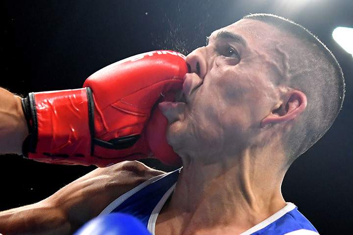France’s Sofiane Oumiha lands a punch on Honduras’ Teofimo Andres Lopez Rivera during the men’s light match at the Rio 2016 Olympic Games in Rio de Janeiro on August 7, 2016.