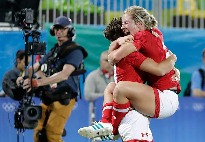 Canada’s Kayla Moleschi celebrates with teammate Ghislaine Landry after scoring the winning try during the women’s rugby sevens quarter final match against France at the Summer Olympics in Rio de Janeiro, Brazil on Sunday, Aug. 7, 2016.