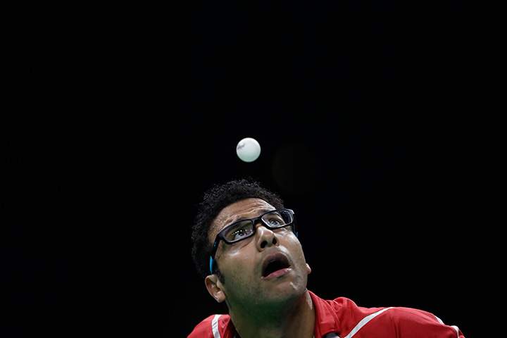 Omar Assar of Egypt eyes the ball as he plays against Lei Kou of Ukraine during their table tennis match at the 2016 Summer Olympics in Rio de Janeiro, Brazil, Sunday, Aug. 7, 2016.