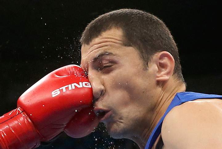 Rustam Tulaganov of Uzbekistan and Abdulkadir Abdullayev of Azerbaijan compete during the men’s 91kg quarterfinal match.
