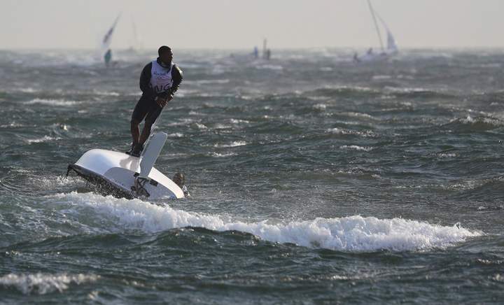 Matias Montinho (ANG) of Angola and Paixao Afonso (ANG) of Angola capsize after the wind suddenly shifted and increased.