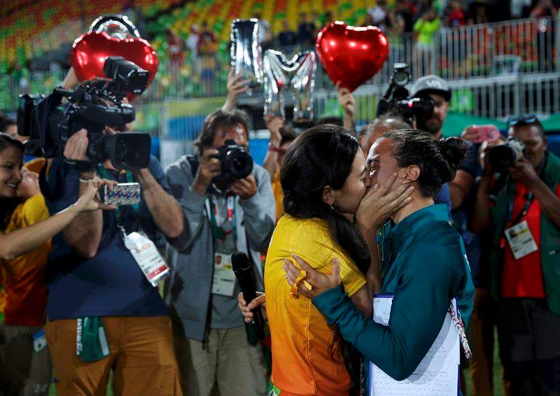 Rugby player Isadora Cerullo of Brazil embraces Marjorie, a volunteer, after receiving her wedding proposal on the sidelines of the women's rugby medal ceremony. 