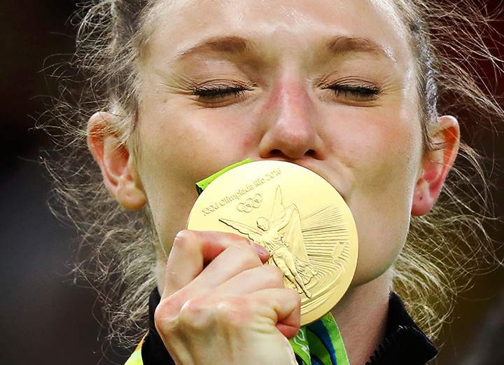Canada’s Rosie MacLennan kisses her gold medal after winning the women’s trampoline final.