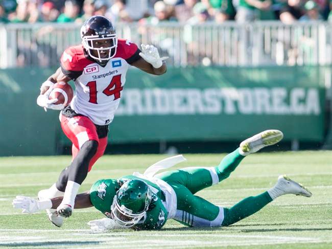 algary Stampeders running back Roy Finch (14) avoids a tackle from Saskatchewan Roughriders defensive back Major Culbert (22) during the first half of CFL football action in Regina on Saturday, August 13, 2016.