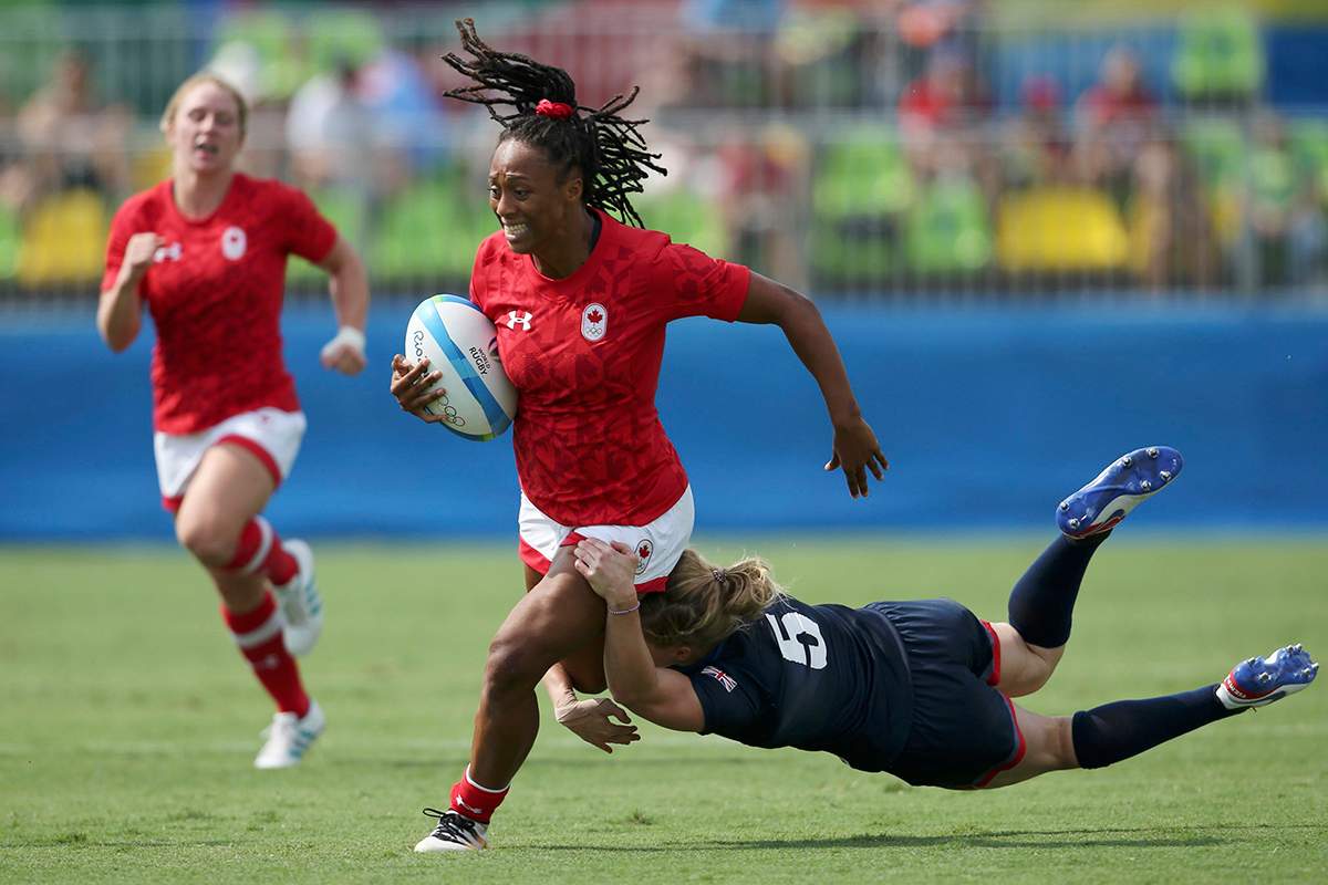 Charity Williams of Canada is tackled by Danielle Waterman of United Kingdom. 