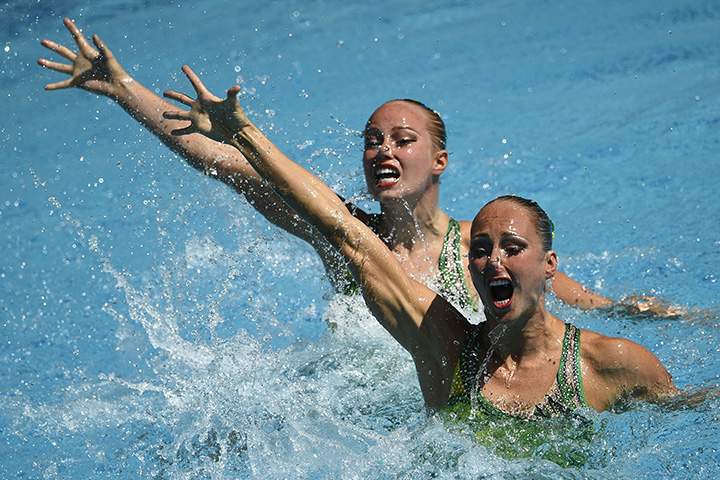 Canada’s Jacqueline Simoneau and Canada’s Karine Thomas compete in the duets technical routine preliminaries during the synchronized swimming event at the Maria Lenk Aquatics at the Rio 2016 Olympic Games in Rio de Janeiro on August 15, 2016.