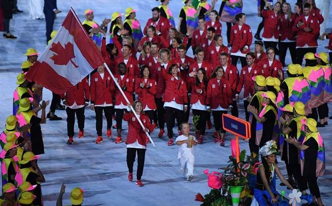 Rosie MacLennan leads team Canada into the stadium during the opening ceremonies at the 2016 Olympic Games in Rio de Janeiro, Brazil on Friday, Aug. 5, 2016.