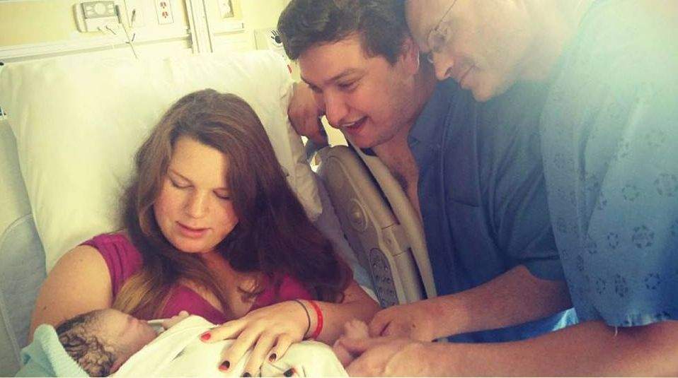 Surrogate Heather Gunn with the couple she carried a baby for twice.