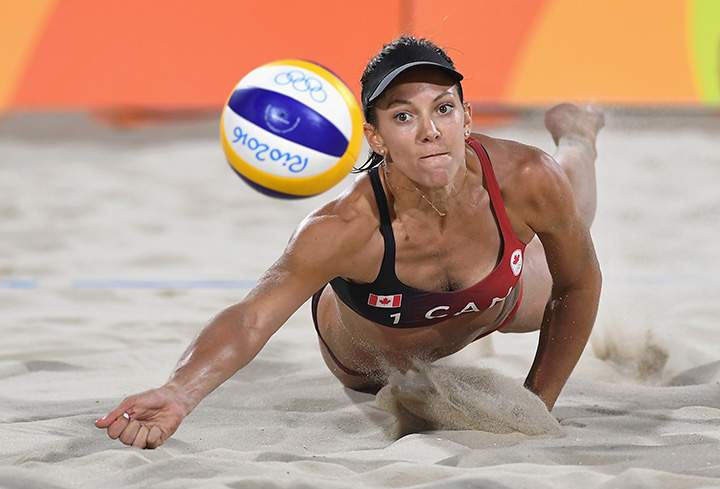 Canada’s Jamie Lynn Broder dives for the ball during the Women’s Beach Volleyball preliminary round Pool D match against Marta Menegatti and Laura Giombini of Italy on Day 2 of the Rio 2016 Olympic Games on August 7, 2016 in Brazil.
