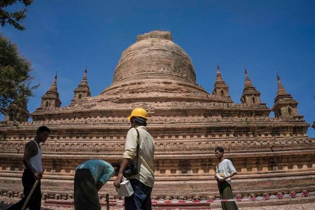 Workers set the security line around the earthquake-damaged Sitanagyi Pagoda in Bagan, Myanmar, Thursday, Aug. 25, 2016.