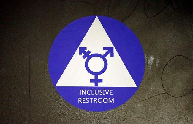 In this May 17, 2016, file photo, a new sticker designates a gender neutral bathroom at Nathan Hale high school in Seattle.