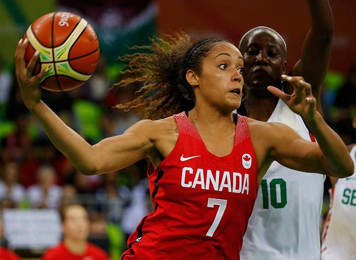 Canada’s Nayo Raincock-Ekunwe and Astou Traore of Senegal compete during preliminary Group B action on August 10, 2016. 