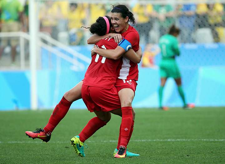 Canada’s Christine Sinclair and Desiree Scott celebrate winning the bronze medal match against Brazil at the Rio Olympics on August 19, 2016.