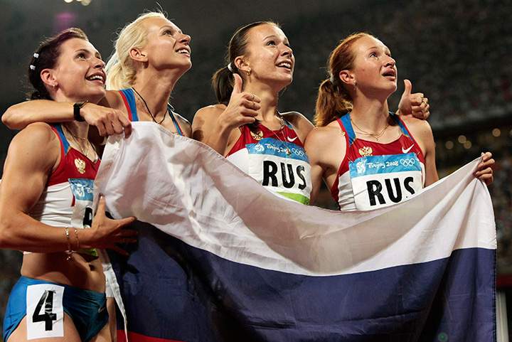 Russia's Yuliya Chermoshanskaya, 2nd right, Yulia Gushchina, Evgeniya Polyakova, left, and  Aleksandra Fedoriva, right,  celebrate winning the gold in the women's 4x100m relay final during the athletics competitions in the National Stadium at the Beijing 2008 Olympics in Beijing, Friday, Aug. 22, 2008.  